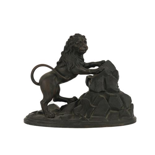 A PATINATED BRONZE MODEL OF A LION