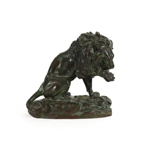 CHARLES VALTON (1851-1918): A PATINATED BRONZE OF A LION LICKING PAW OVER PREY