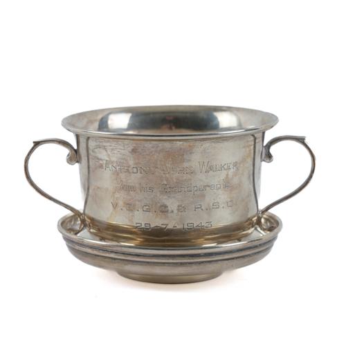 A SILVER TWIN HANDLED CHRISTENING CUP AND SAUCER (2)