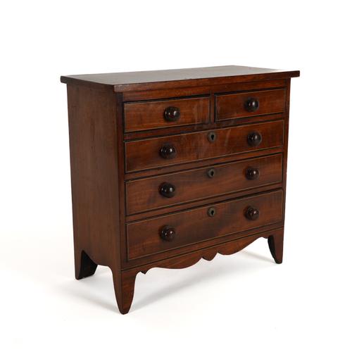 A GEORGE III MAHOGANY BOXWOOD AND EBONY STRUNG MINIATURE CHEST OF DRAWERS