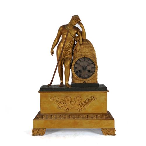 A FRENCH RESTAURATION GILT AND PATINATED BRONZE MANTLE CLOCK