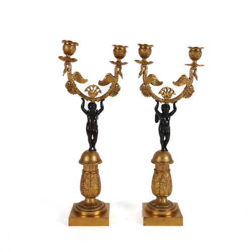 A PAIR OF FRENCH RESTAURATION GILT AND PATINATED METAL TWIN LIGHT CANDELABRA (2)