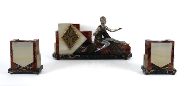 A FRENCH ART DECO RED MARBLE AND ALABASTER FIGURAL THREE-PIECE CLOCK GARNITURE (3)