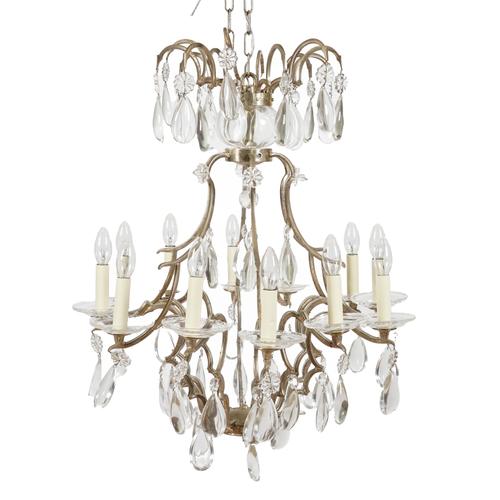 A GLASS MOUNTED SILVERED METAL TWELVE LIGHT CHANDELIER
