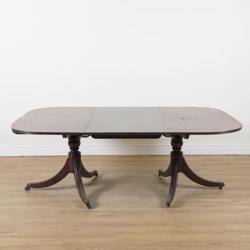 A GEORGE III AND LATER MAHOGANY TWIN PILLAR EXTENDING DINING TABLE