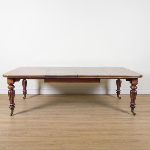 A VICTORIAN MAHOGANY EXTENDING DINING TABLE