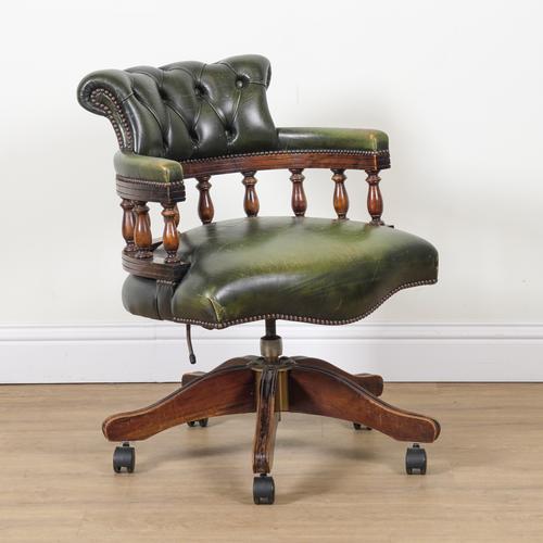 A STAINED BEECH FRAMED TUB BACK REVOLVING DESK CHAIR