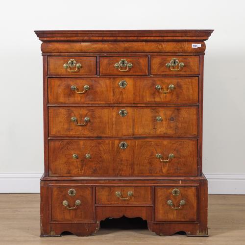 A GEORGE I FIGURED WALNUT CHEST ON STAND