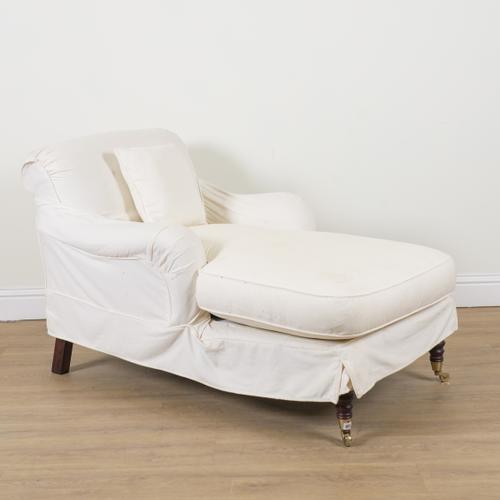 A CREAM UPHOLSTERED WING BACK CHAISE LONGUE