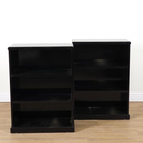 A PAIR OF MODERN EBONISED FLOOR STANDING THREE TIER OPEN BOOKCASES (2)