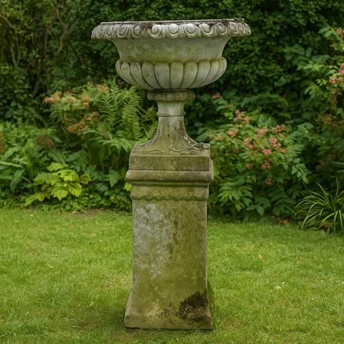 A RECONSTITUTED STONE GARDEN URN