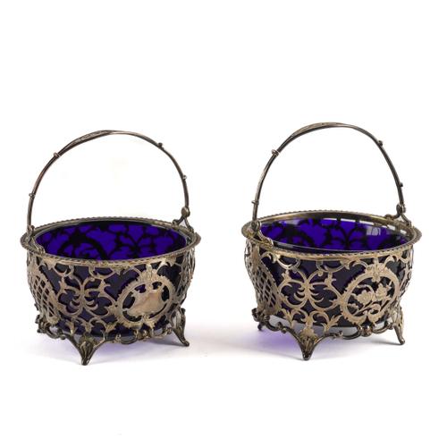 A NEAR PAIR OF SILVER BASKETS (4)