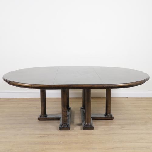 A MODERN OVAL HARDWOOD EXTENDING DINING TABLE