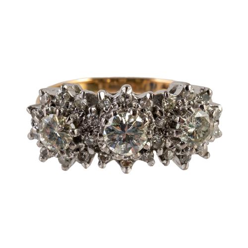 A GOLD AND DIAMOND THREE STONE RING