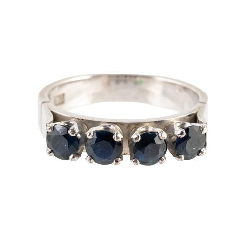 A WHITE GOLD AND SAPPHIRE FOUR STONE RING