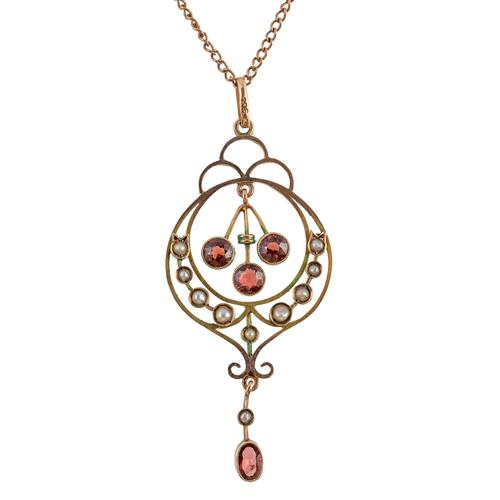 AN EDWARDIAN GOLD, GARNET AND SEED PEARL PENDANT