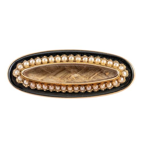 A VICTORIAN GOLD, SEED PEARL AND BLACK ONYX MOURNING BROOCH