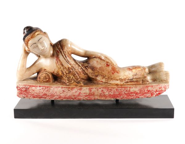 AN INDIAN CARVED ALABASTER SCULPTURE OF A RECLINING FEMALE