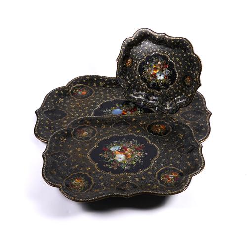A SET OF THREE GRADUATED VICTORIAN GILT HEIGHTENED MOTHER-OF-PEARL DECORATED PAPIER-MACHE TRAYS (3)