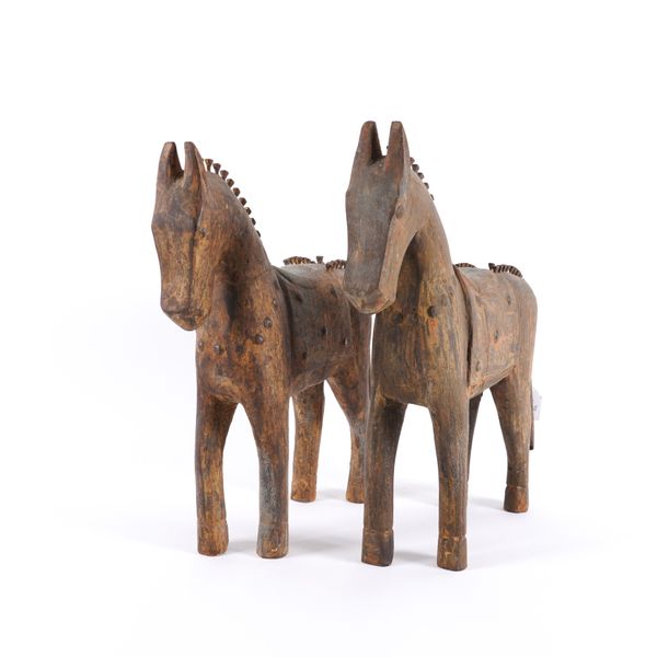 A PAIR OF HARDWOOD AND IRON MOUNTED CARVED HORSES (2)