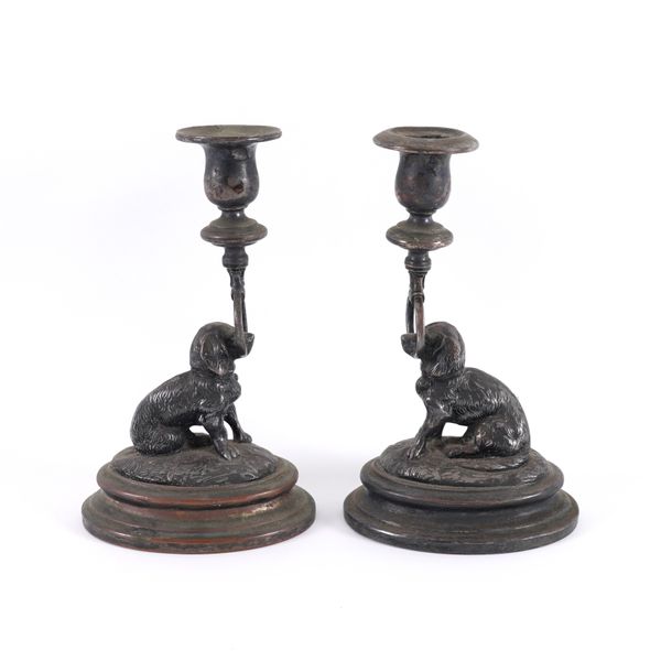 A PAIR OF SILVER PLATED DOG CANDLESTICKS (2)