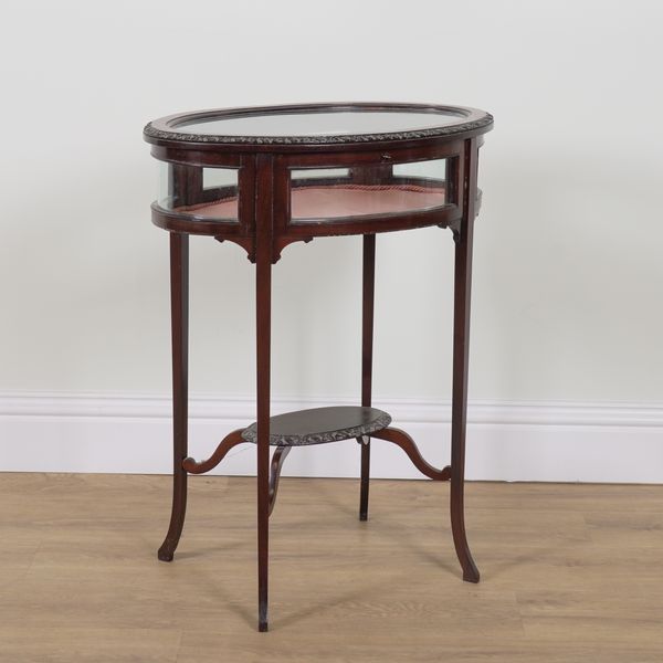 AN EDWARDIAN MAHOGANY OVAL BIJOUTERIE TABLE