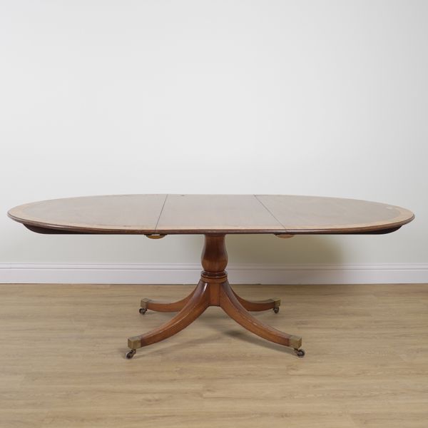 A GEORGE III SATINWOOD BANDED MAHOGANY OVAL EXTENDING DINING TABLE