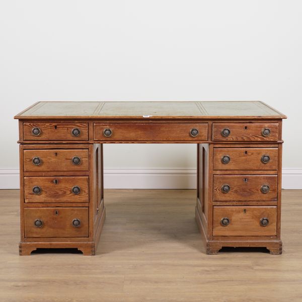 A LATE 19TH CENTURY PITCH PINE NINE DRAWER PEDESTAL DESK