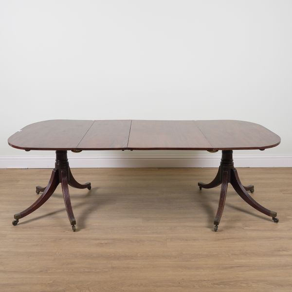 A GEORGE III MAHOGANY D-END TWIN PILLAR EXTENDING DINING TABLE