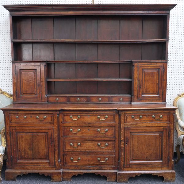 A GEORGE III OAK INVERTED BREAKFRONT KITCHEN DRESSER