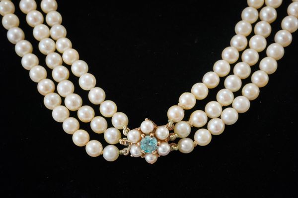 A THREE STRAND CULTURED PEARL NECKLACE