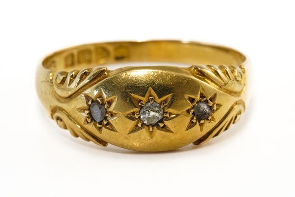 AN 18CT GOLD AND DIAMOND THREE STONE RING