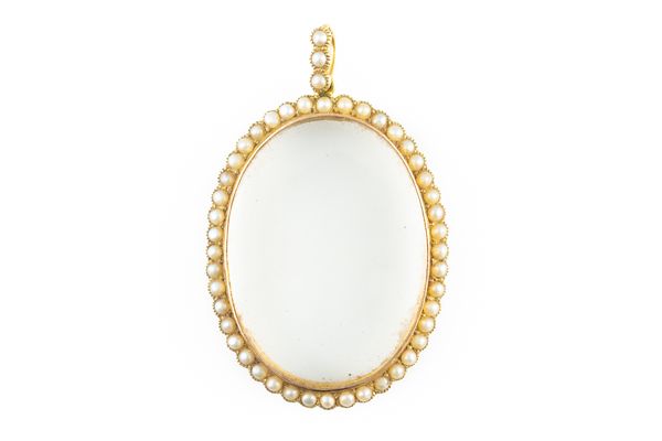 A GOLD AND HALF PEARL SET OVAL PENDANT LOCKET