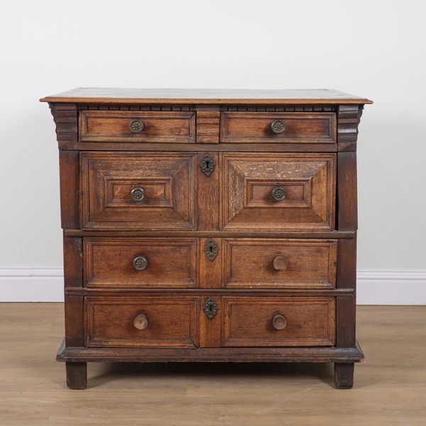 A CHARLES II CHEST OF FOUR RAISED GEOMETRIC PANELLED DRAWERS