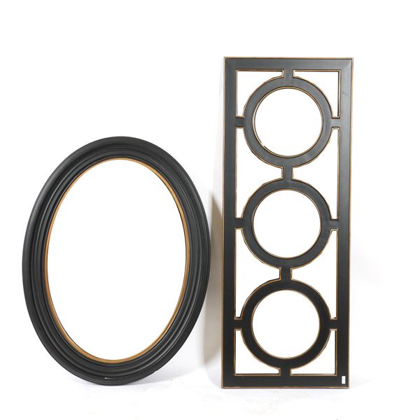 AN EBONISED OVAL MIRROR (2)