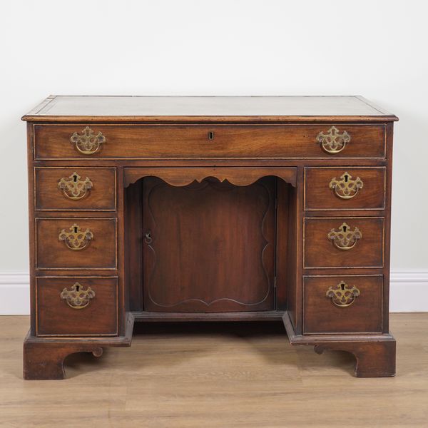 A GEORGE III MAHOGANY KNEEHOLE WRITING DESK