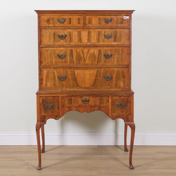 A GEORGE I STYLE FIGURED WALNUT FIVE DRAWER CHEST ON STAND