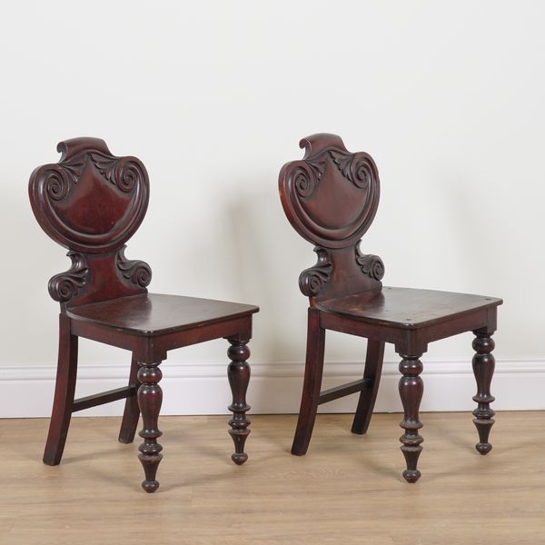 A PAIR OF VICTORIAN CARVED MAHOGANY HALL CHAIRS (2)