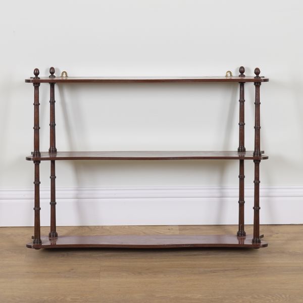 A REGENCY MAHOGANY SERPENTINE THREE TIER HANGING OPEN SHELF