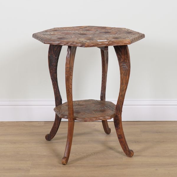 PROBABLY LIBERTY & CO; A FOLIATE CARVED OCTAGONAL TWO TIER OCCASIONAL TABLE