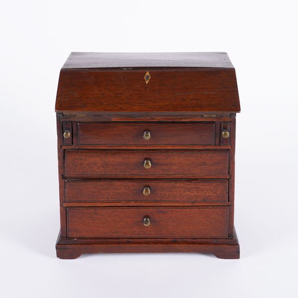 A MINIATURE MAHOGANY FOUR DRAWER BUREAU