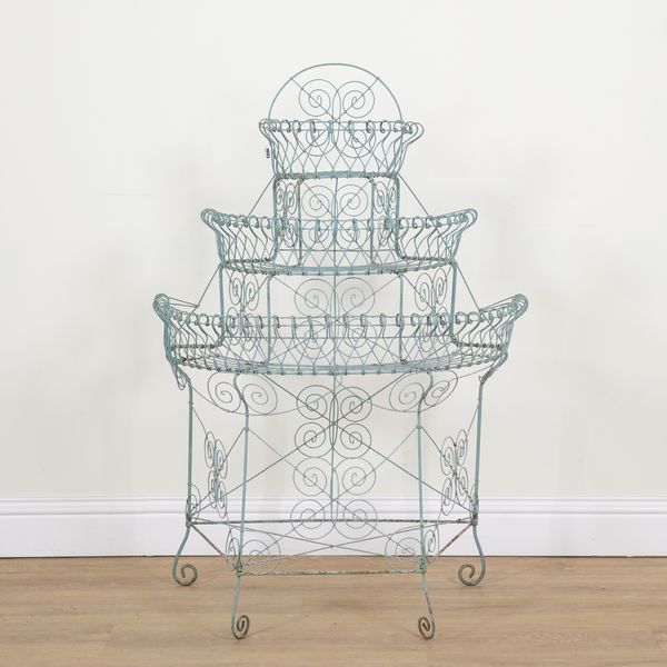 AN EDWARDIAN WIREWORK SEMI-ELLIPTIC THREE TIER PLANT STAND