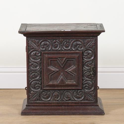 A 17TH CENTURY AND LATER OAK HANGING CUPBOARD