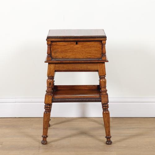 A REGENCY MAHOGANY LIFT TOP SEWING BOX ON STAND