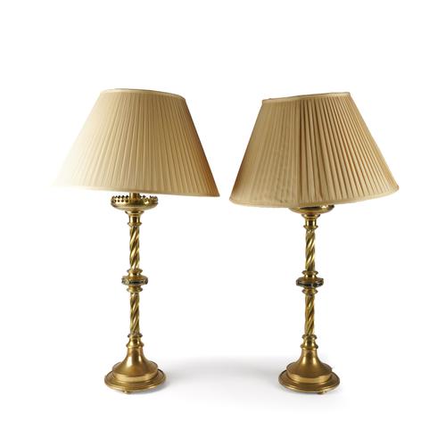 A PAIR OF GOTHIC BRASS ALTAR CANDLESTICKS ADAPTED TO TABLE LAMPS (2)