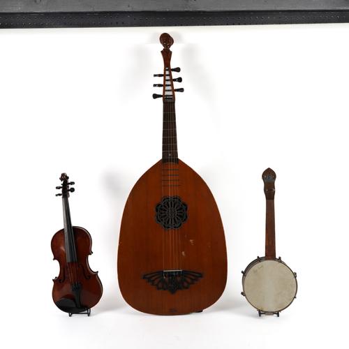 A GROUP OF STRING INSTRUMENTS INCLUDING A RITMULLER LUTE GUITAR (7)