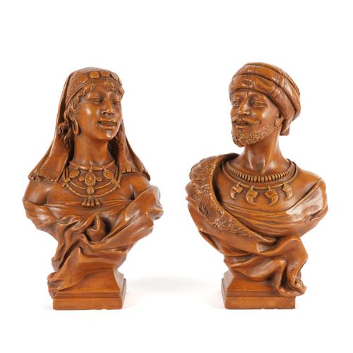 A PAIR OF CONTINENTAL TERRCOTTA COLOURED PLASTER BUSTS OF AN AFRICAN WOMAN AND MAN (2)