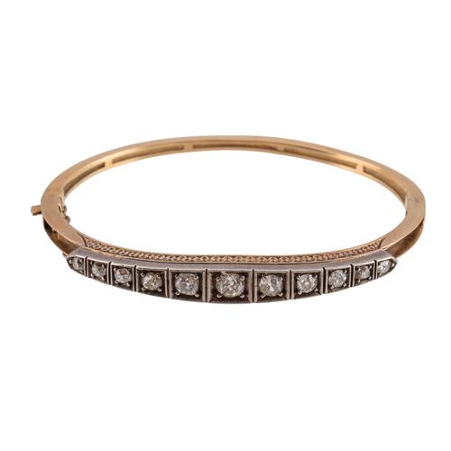 A GOLD AND SILVER SET DIAMOND OVAL HINGED BANGLE