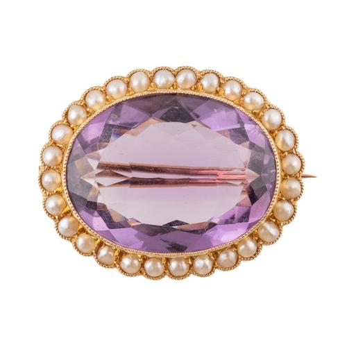 A GOLD, AMETHYST AND HALF PEARL OVAL BROOCH