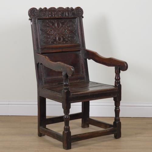 AN EARLY 18TH CENTURY OAK WAINSCOT ARMCHAIR